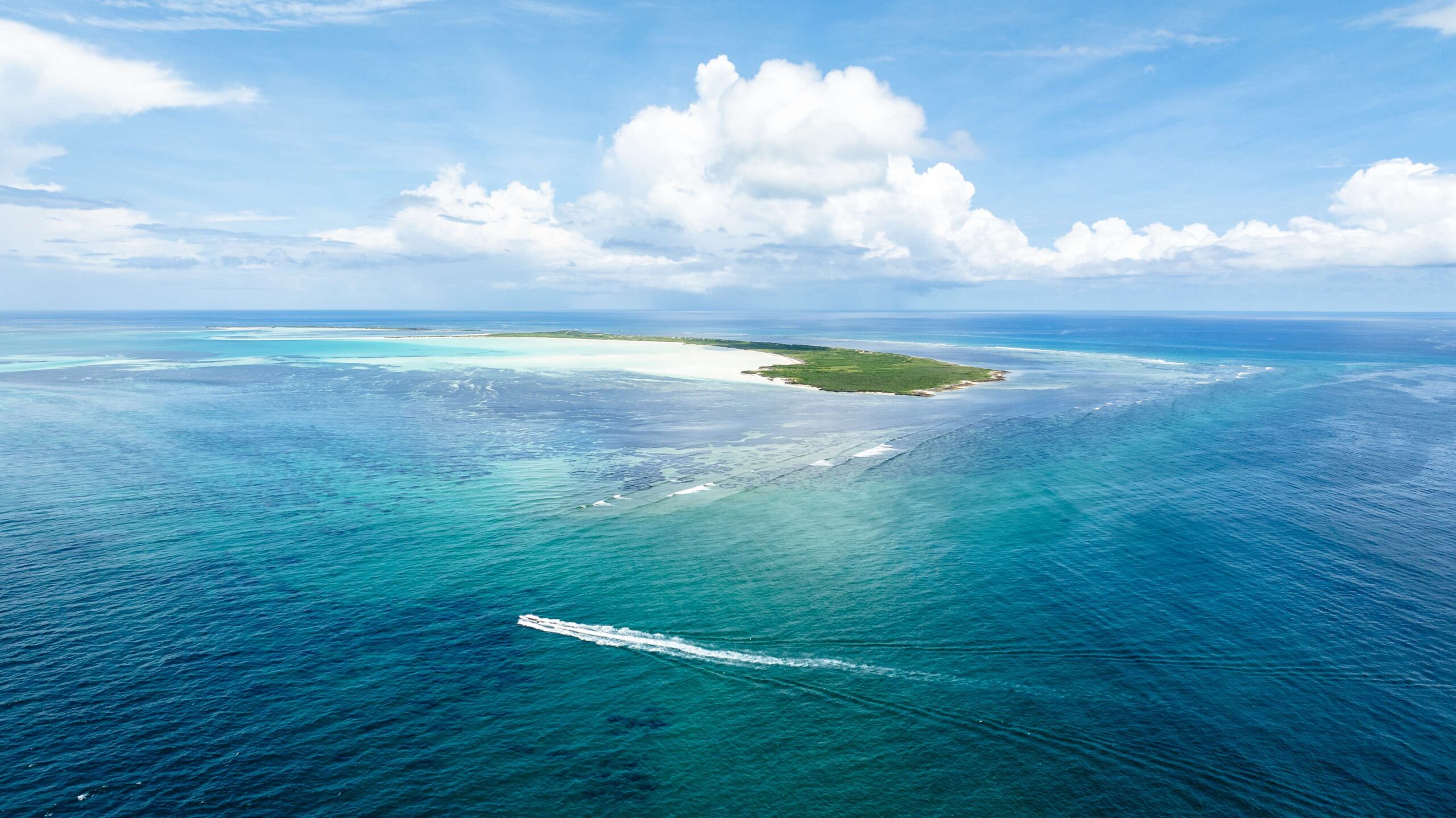 Aerial view of a Blue Safari sandbar with umbrellas and turquoise water